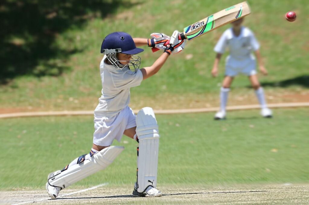 A Kid playing Cricket
